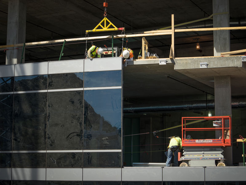construction of glass curtain wall on exterior of building
